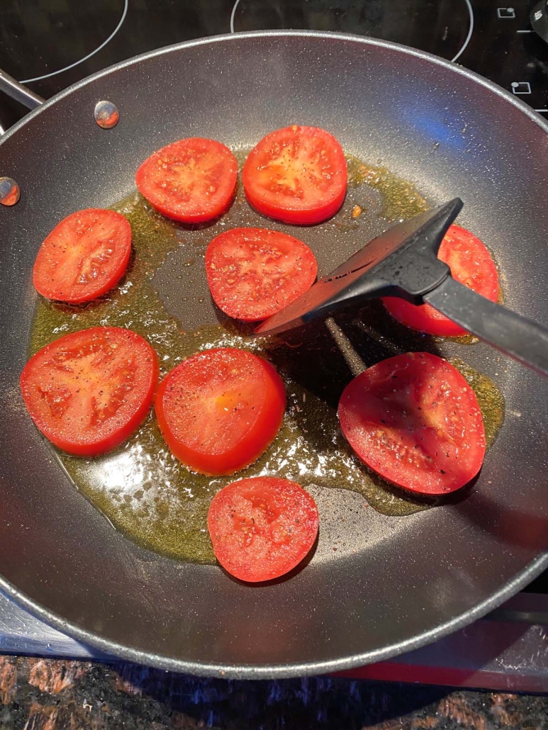 spatula flipping slices of tomato