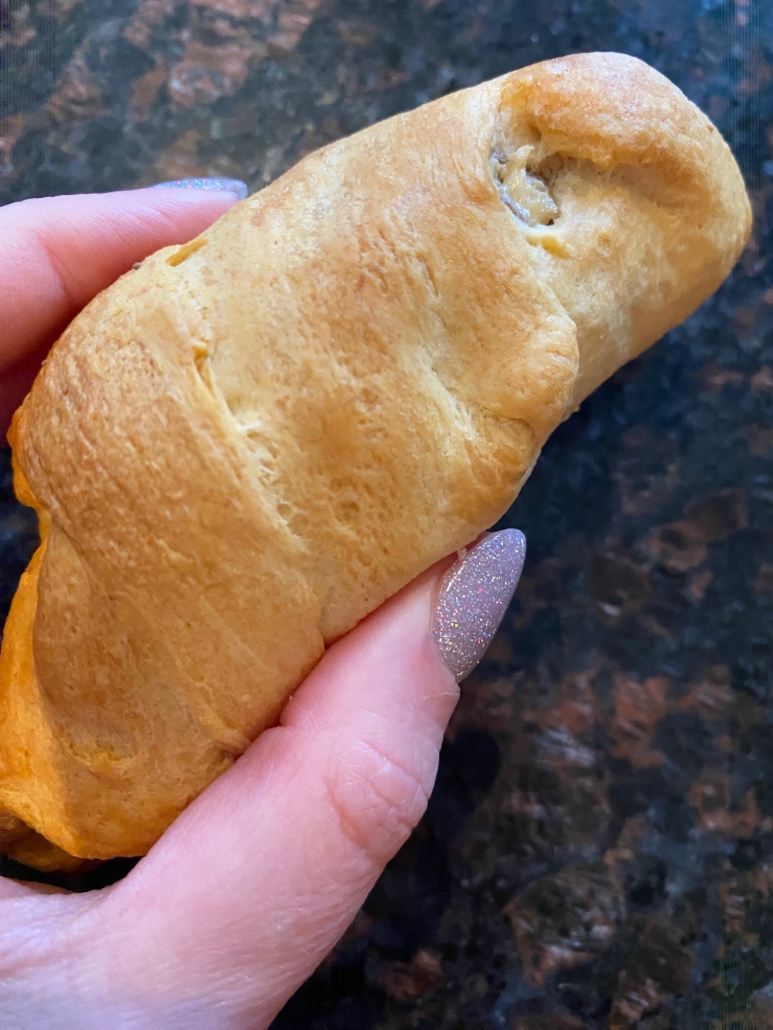 hand holding Sausage Cream Cheese Crescent Roll