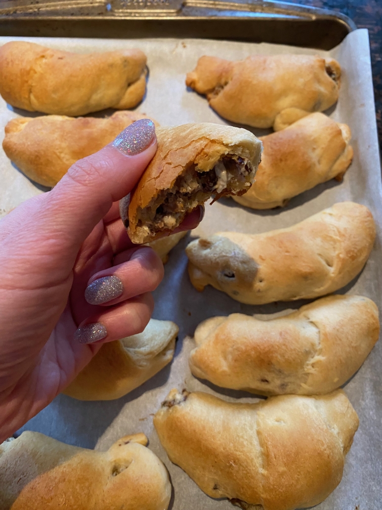 hand holding an opened Sausage Cream Cheese Crescent Roll