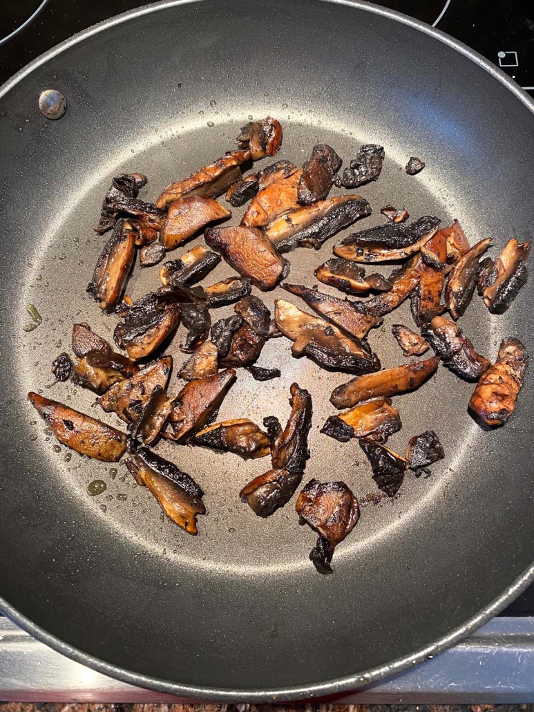 sliced portobello mushrooms in a skillet