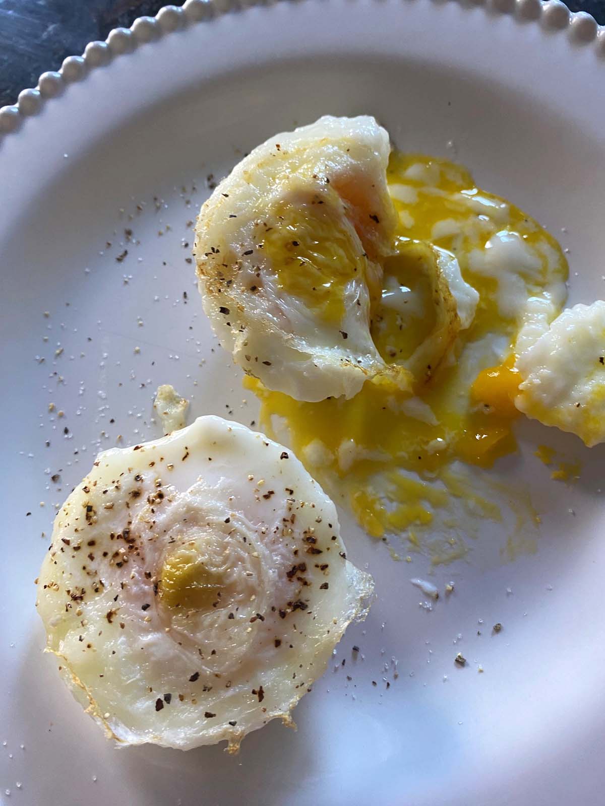Air fryer poached eggs on a white plate.