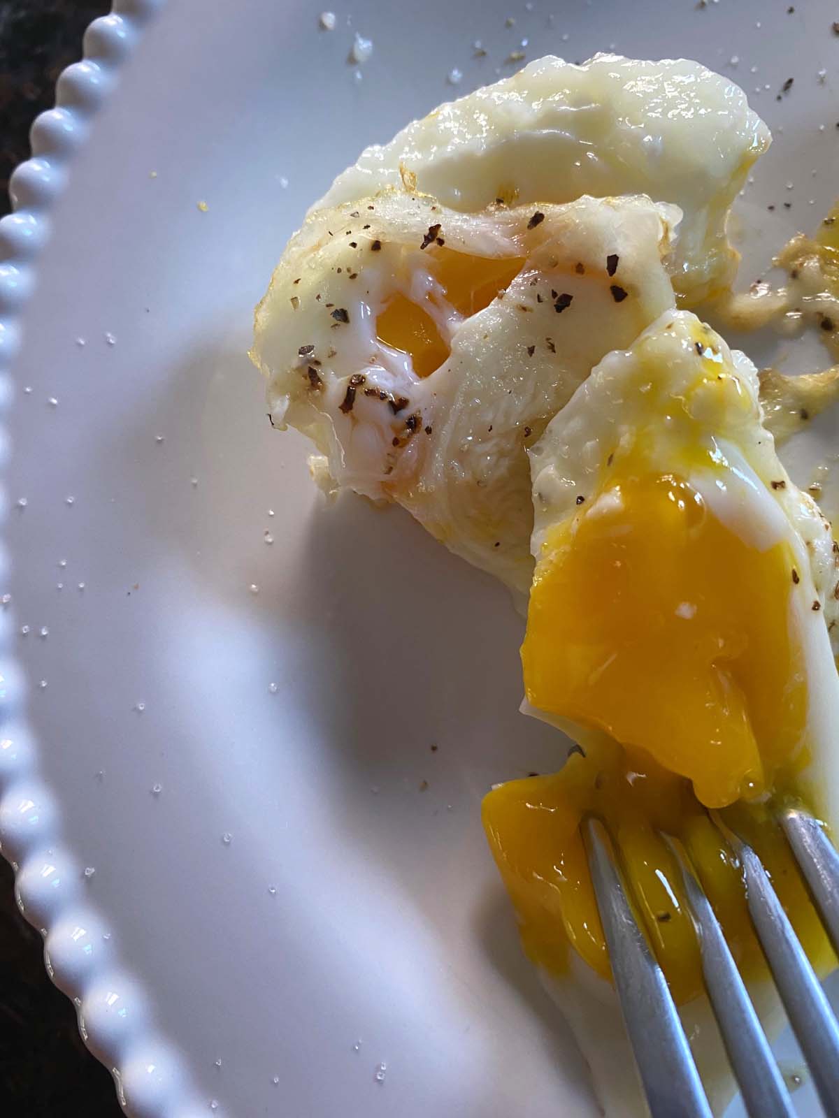 Air fryer poached eggs on a white plate.