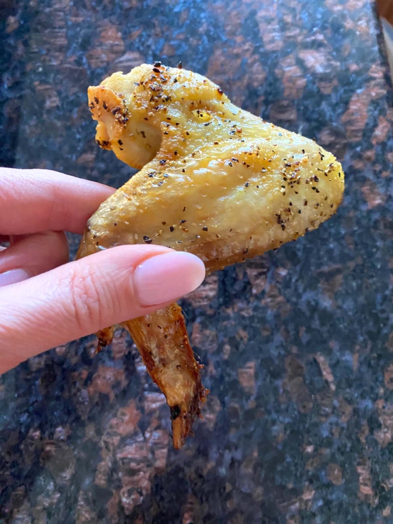 hand holding Baked Lemon Pepper Wing