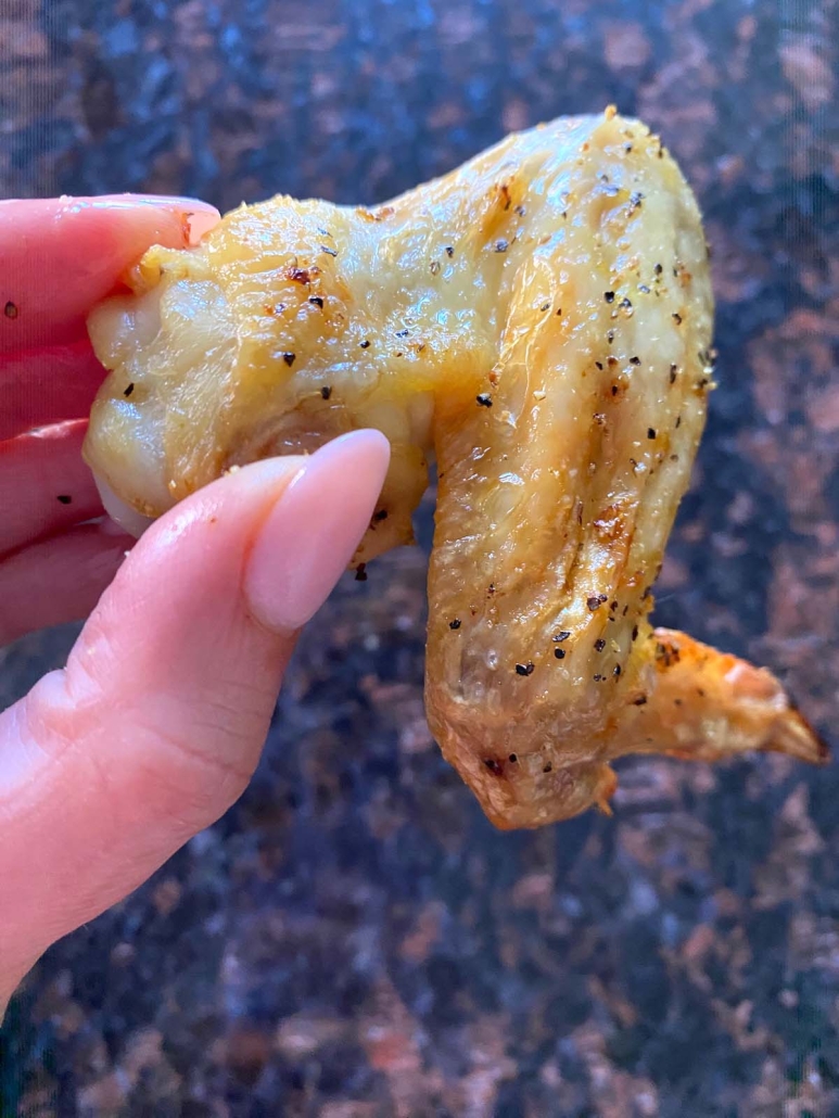 hand holding Baked Lemon Pepper Wing