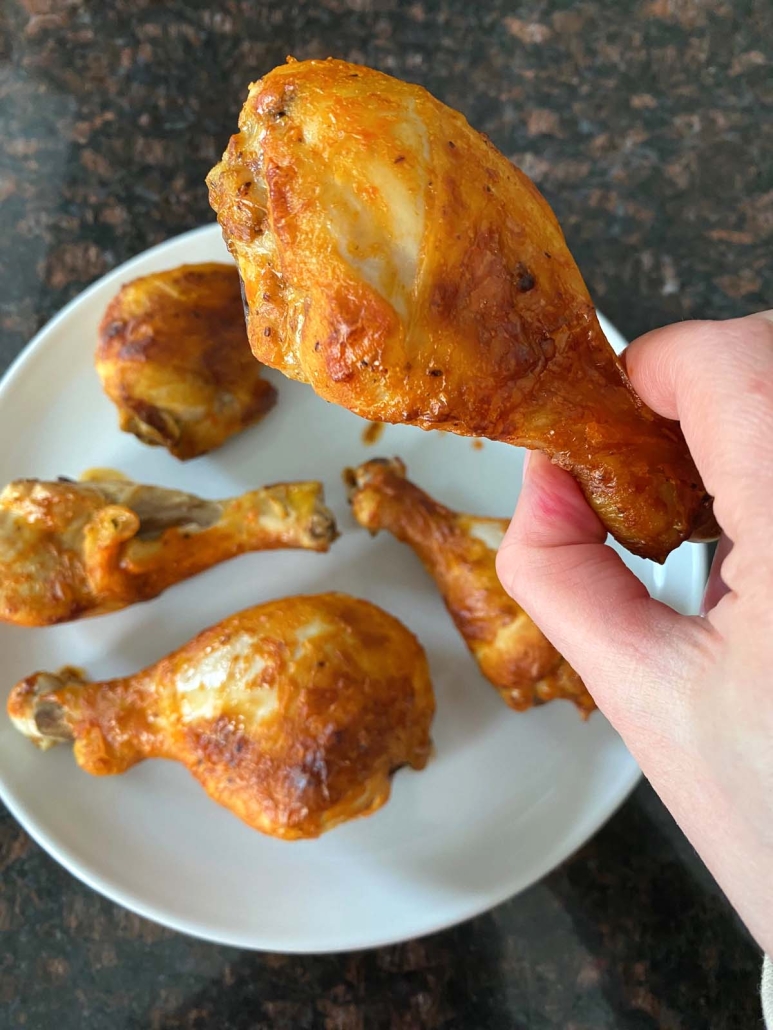 hand holding a Baked Buffalo Chicken Drumstick