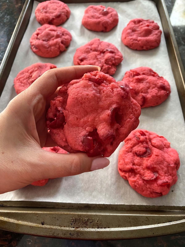 hand holding cherry cookie