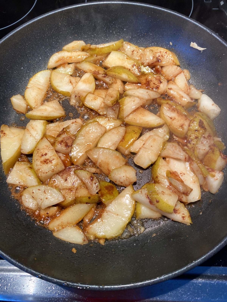 seasoned, sliced pears in skillet