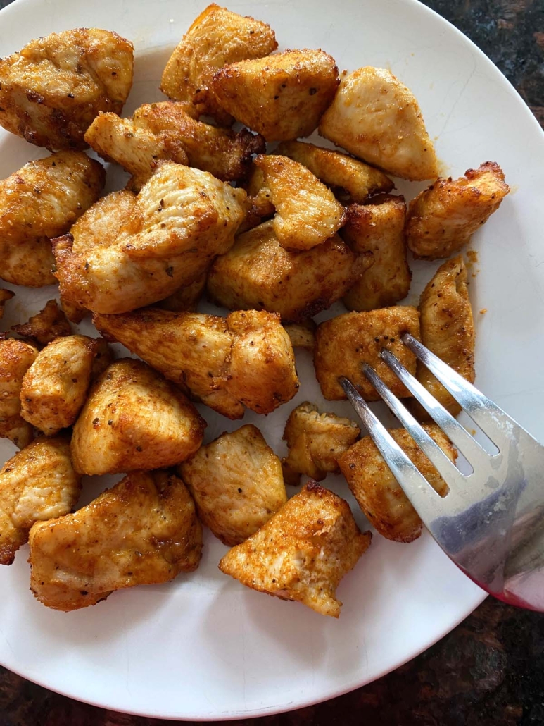 fork holding chicken bite cooked in the air fryer