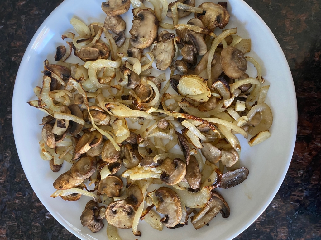 seasoned Air Fryer Mushrooms And Onions on a plate