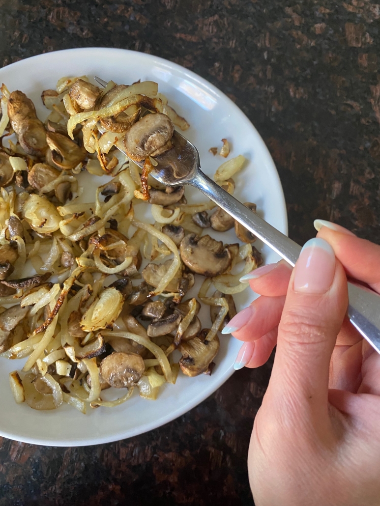 fork with bite of Air Fryer Mushrooms And Onions