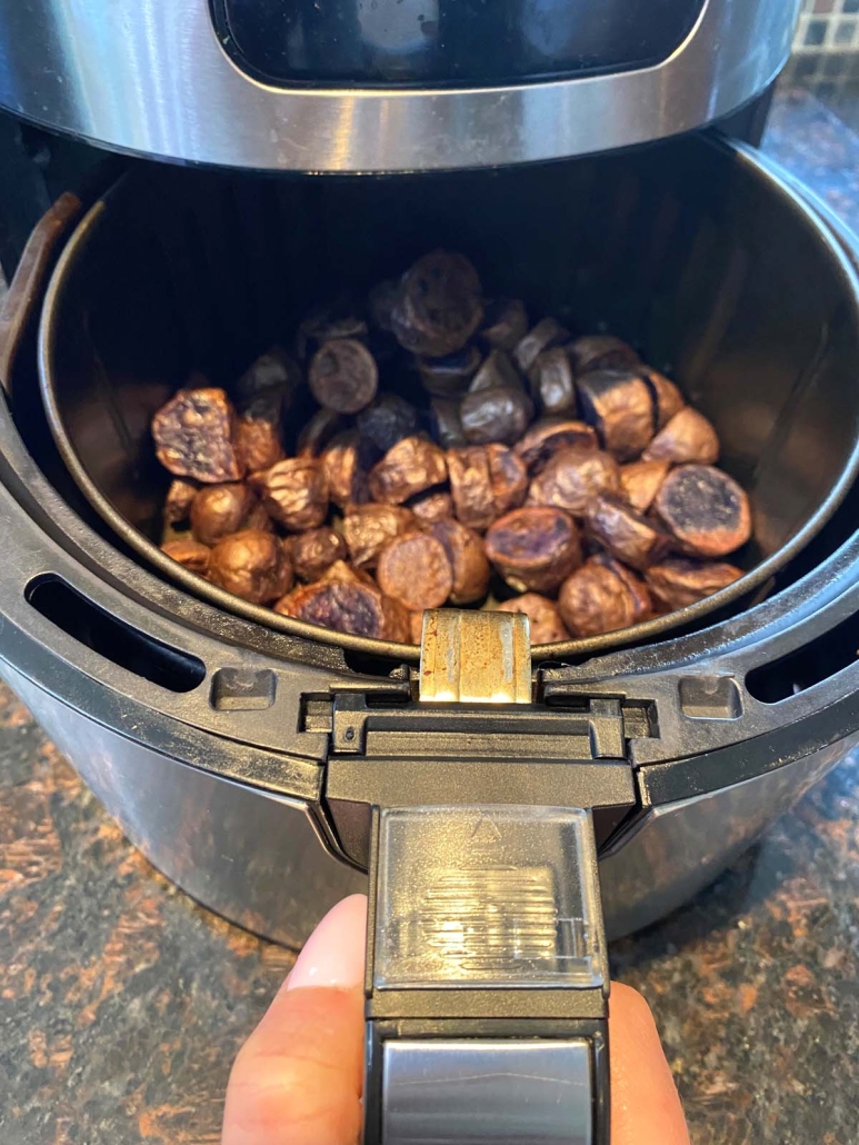 purple potatoes crisping up in air fryer