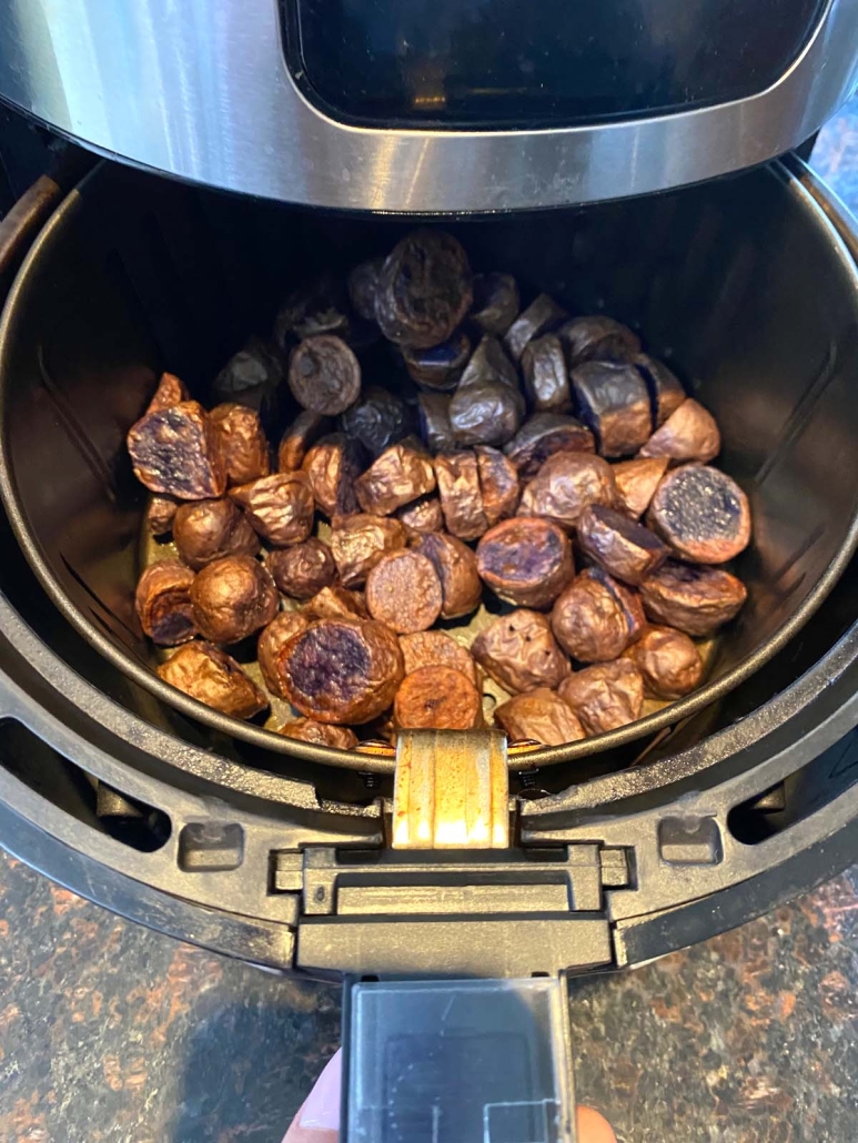 air fryer opened to show Purple Potatoes