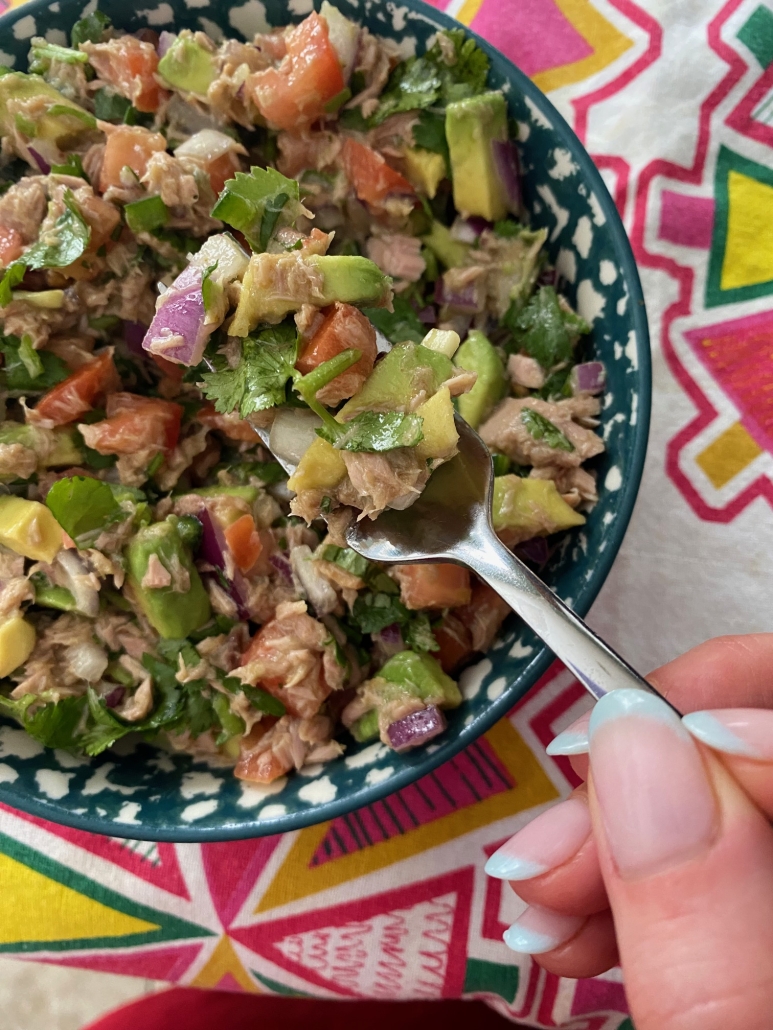 hand holding fork in Canned Tuna Ceviche