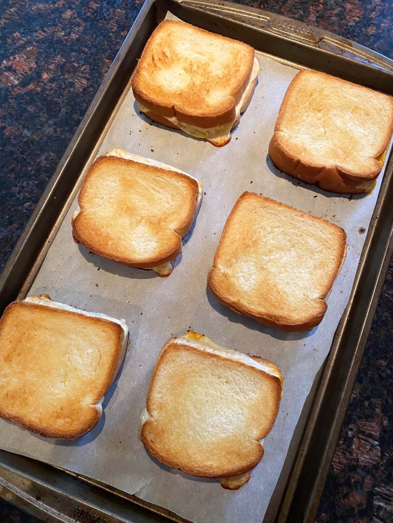 grilled cheese sandwiches on a baking sheet