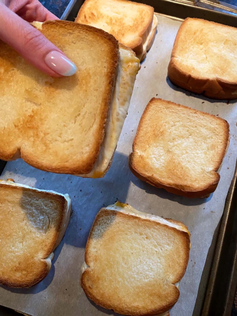 hand holding Grilled Cheese From The Oven