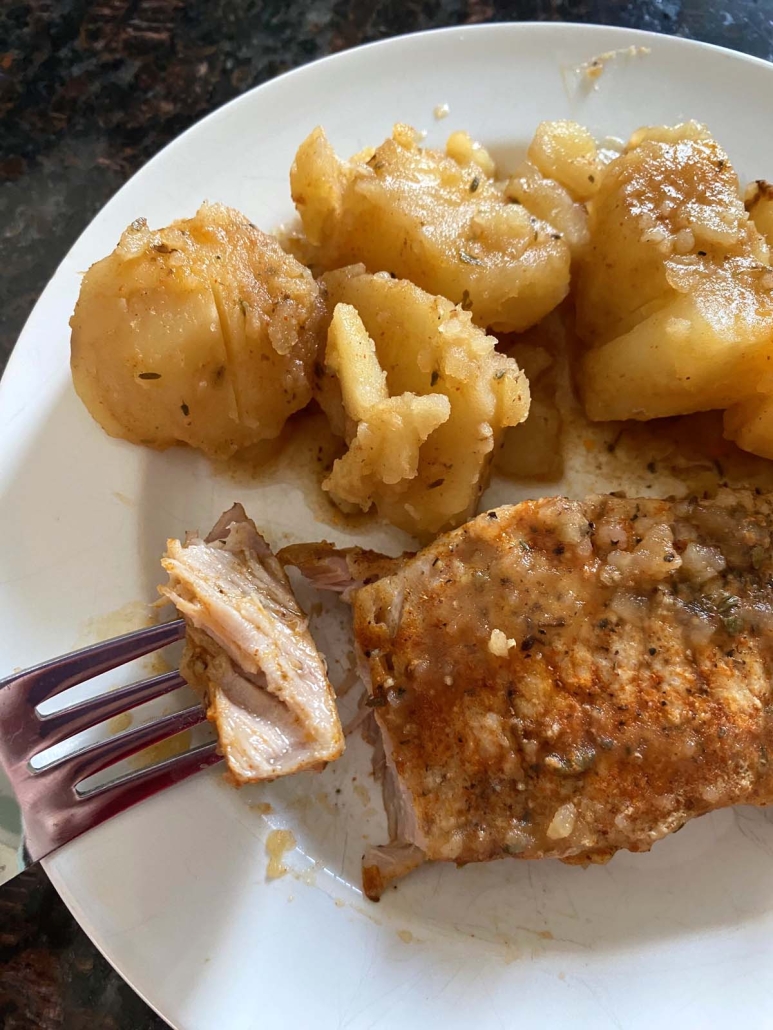 fork holding piece of Instant Pot Pork Chops And Potatoes