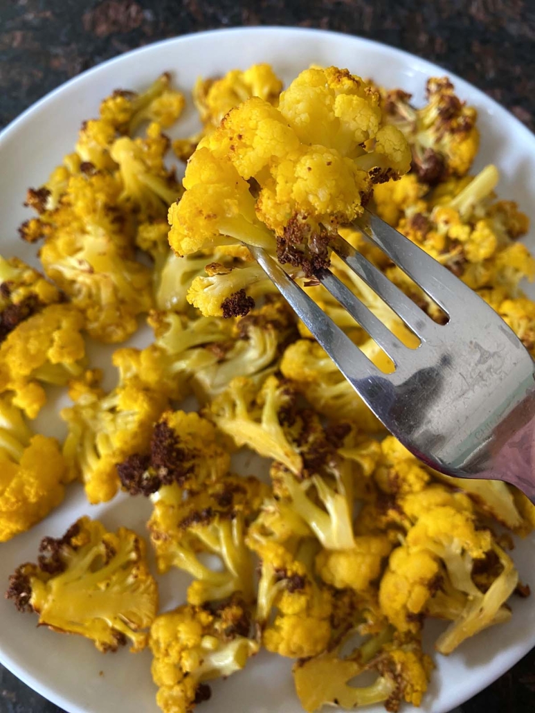fork holding piece of Orange Cauliflower