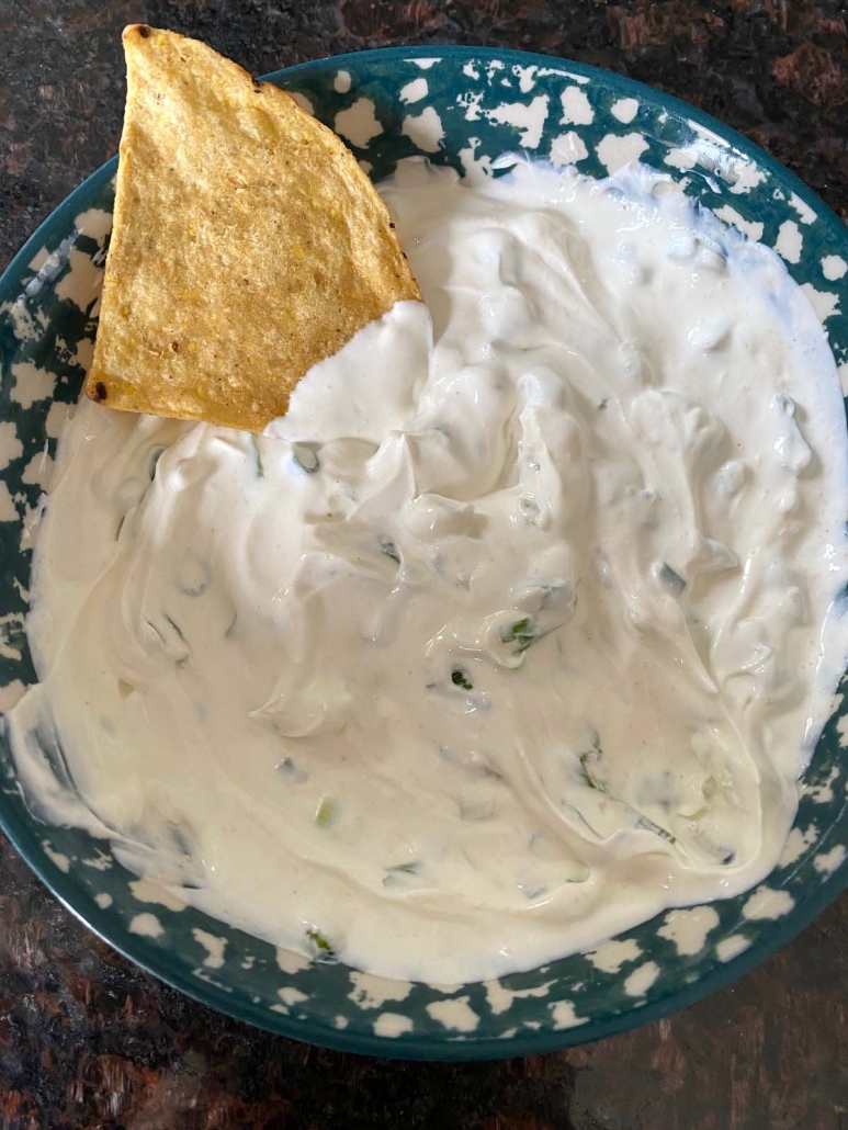 tortilla chip in sour cream and onion dip