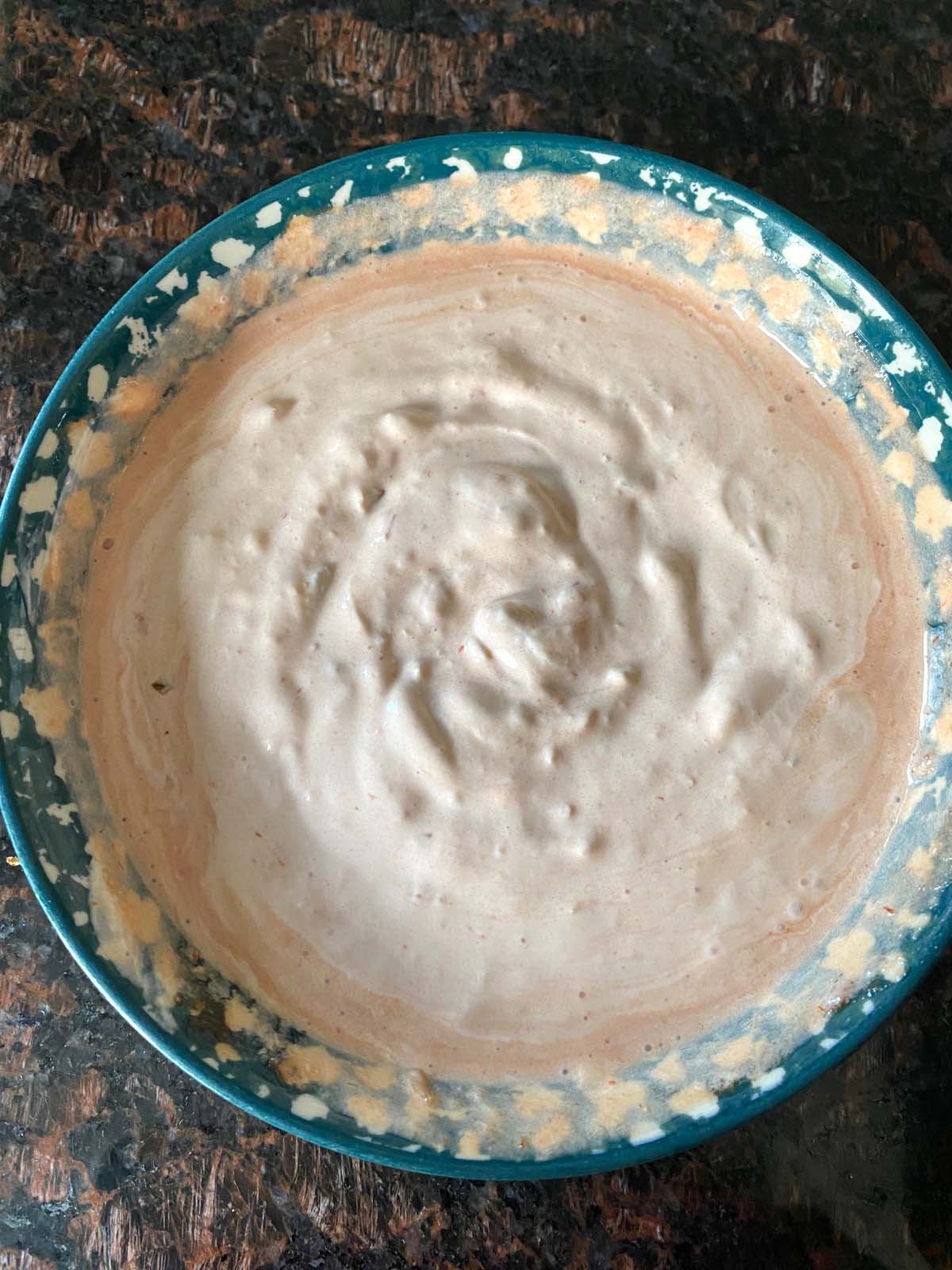 Bowl of sour cream and salsa dip.