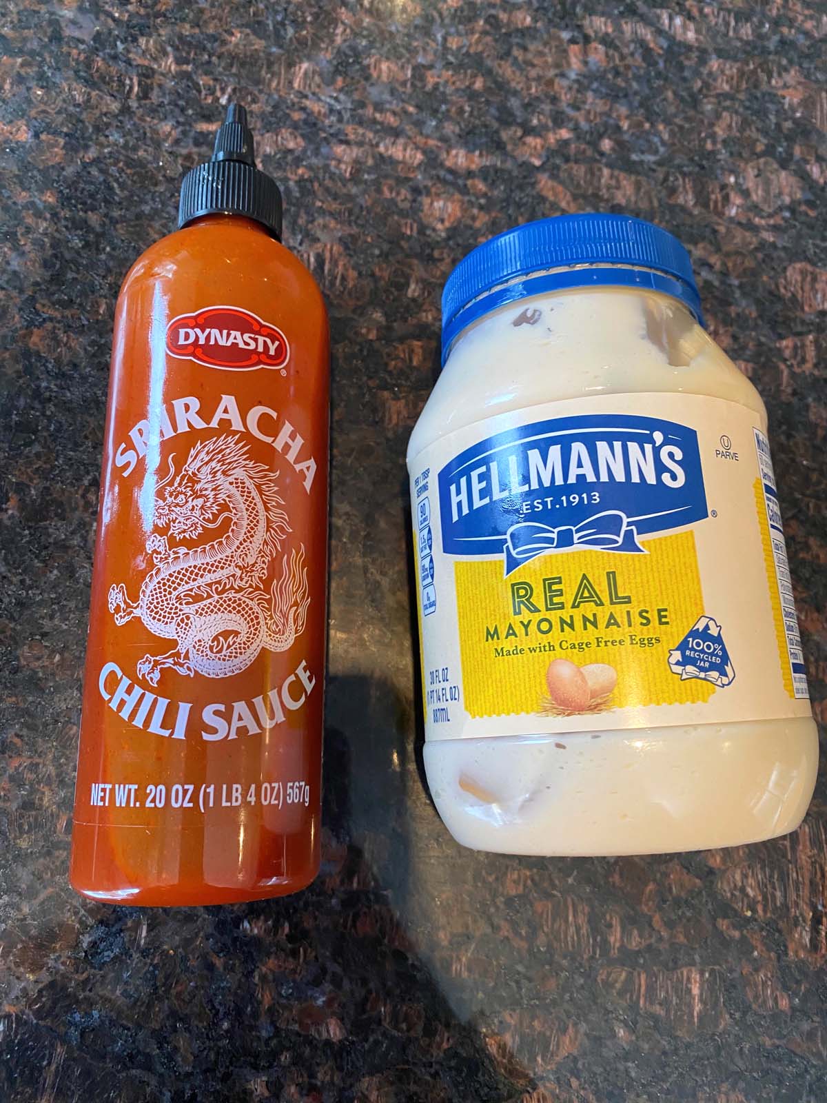 A bottle of sriracha and mayo.