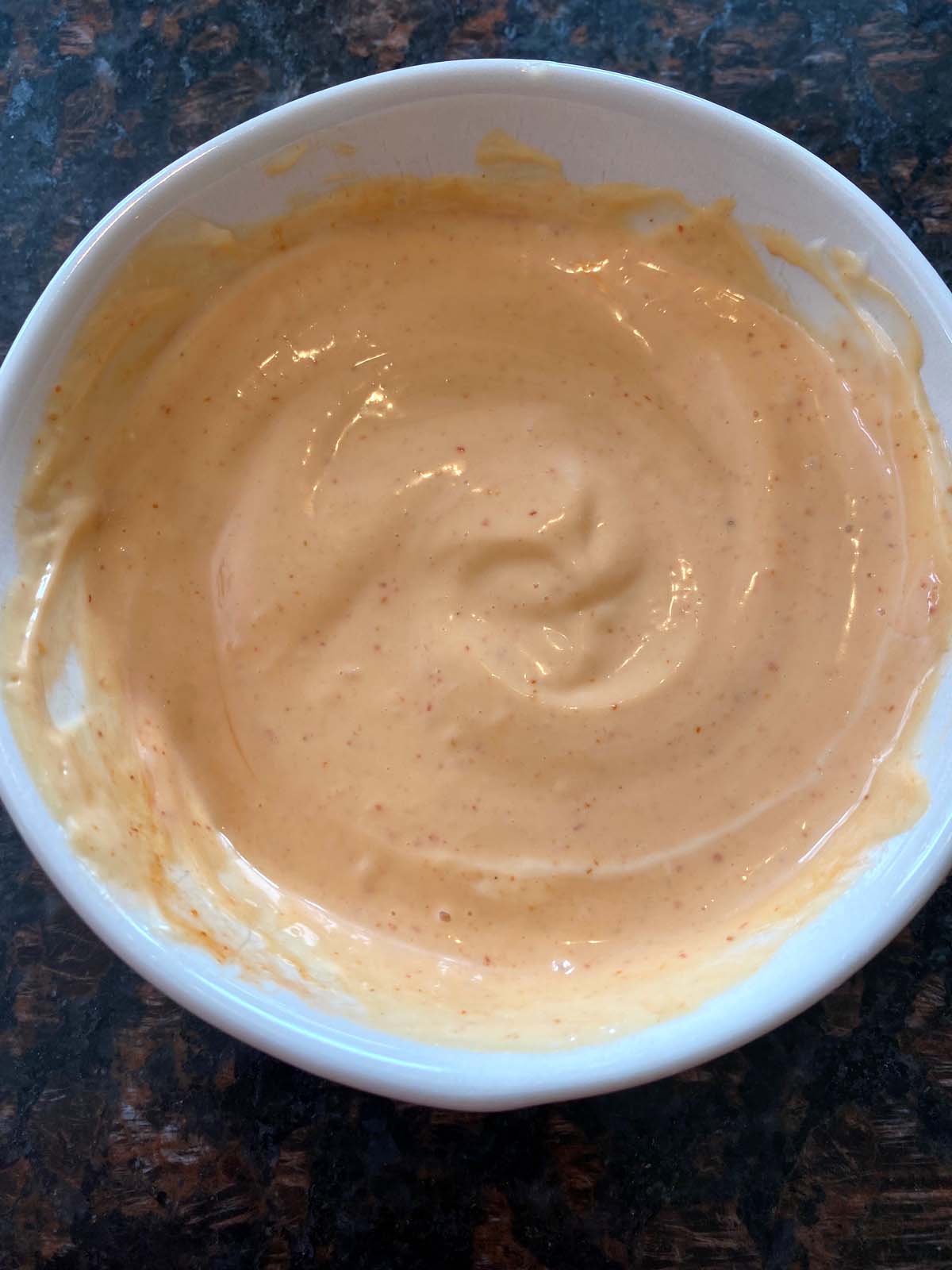 Sriracha spicy mayo in a white bowl.