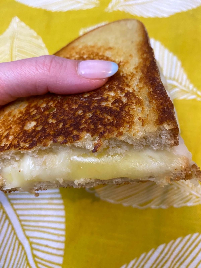 hand holding a piece of Starbucks Grilled Cheese Copycat 