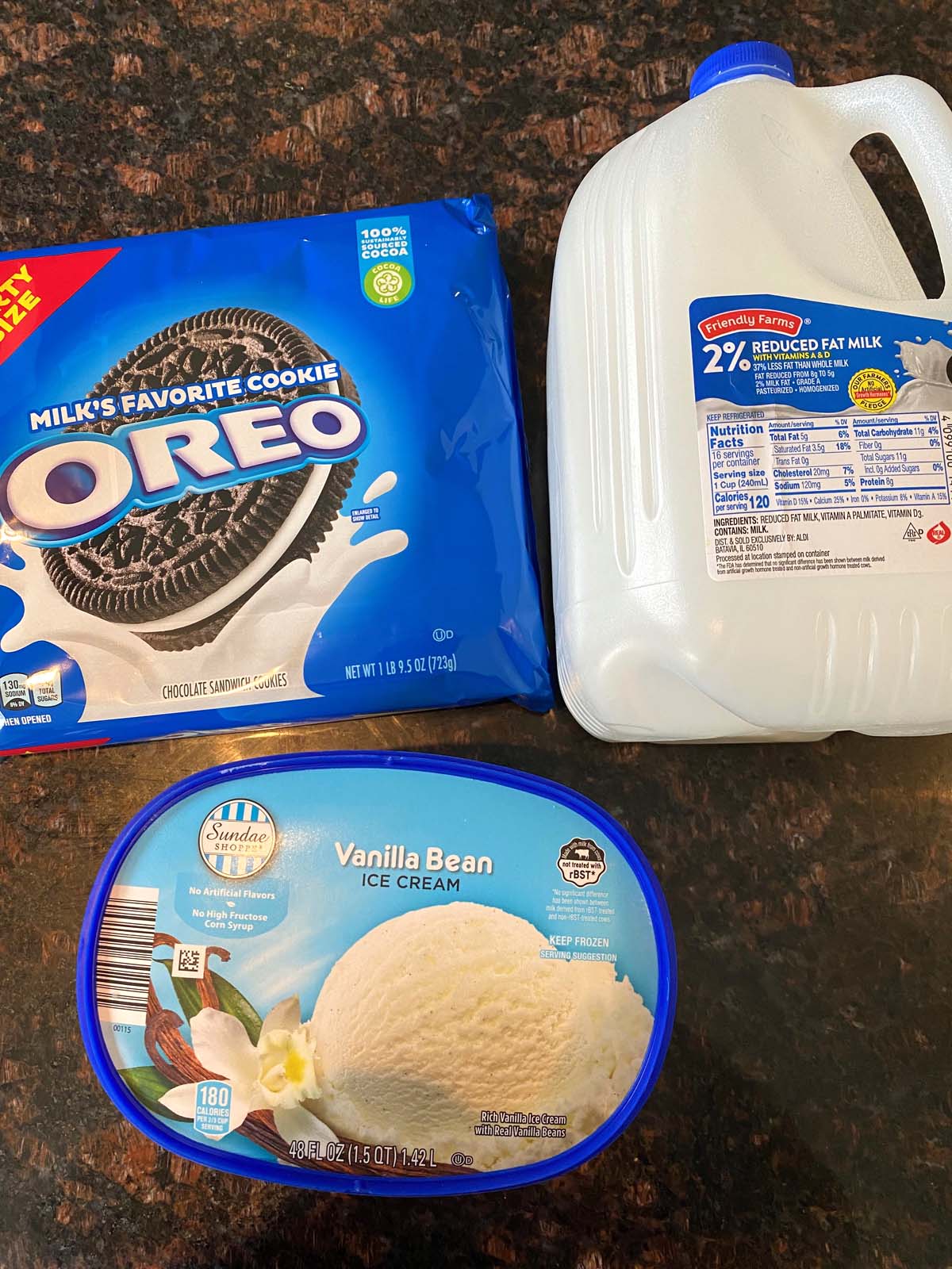 Package of Oreos, gallon of milk, and tub of vanilla ice cream.