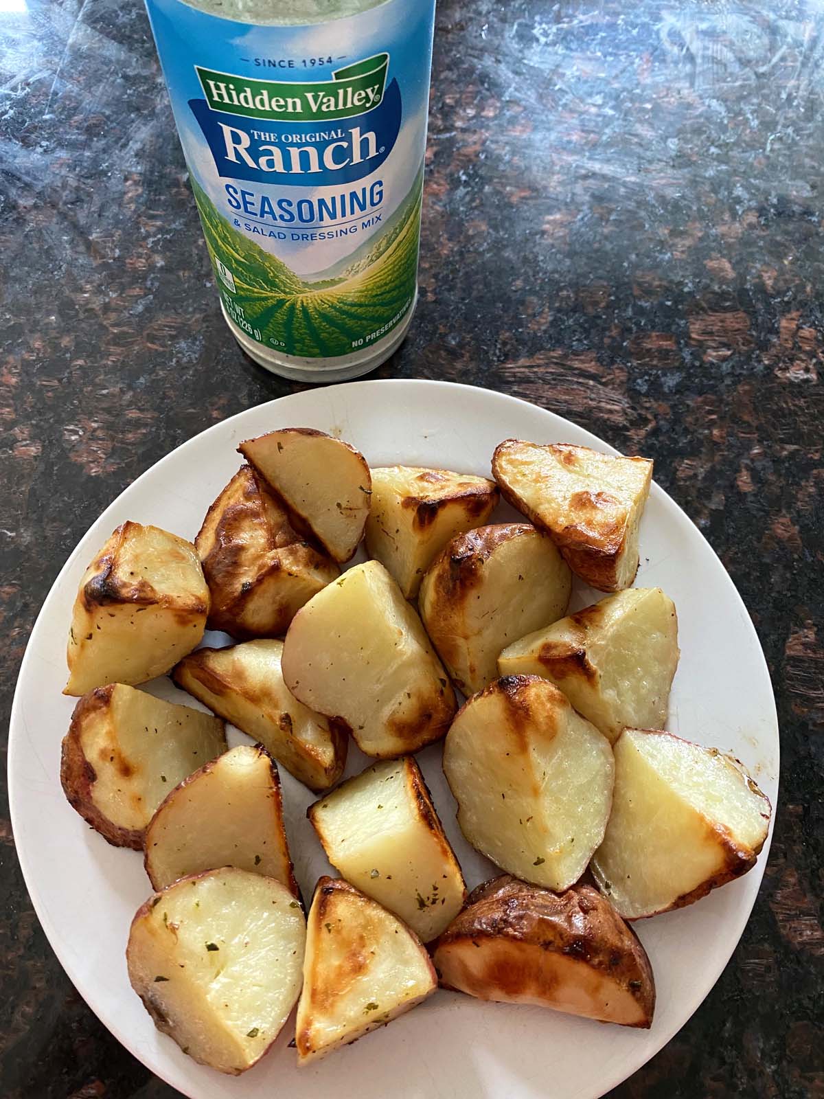 Ranch roasted potatoes on a white plate.
