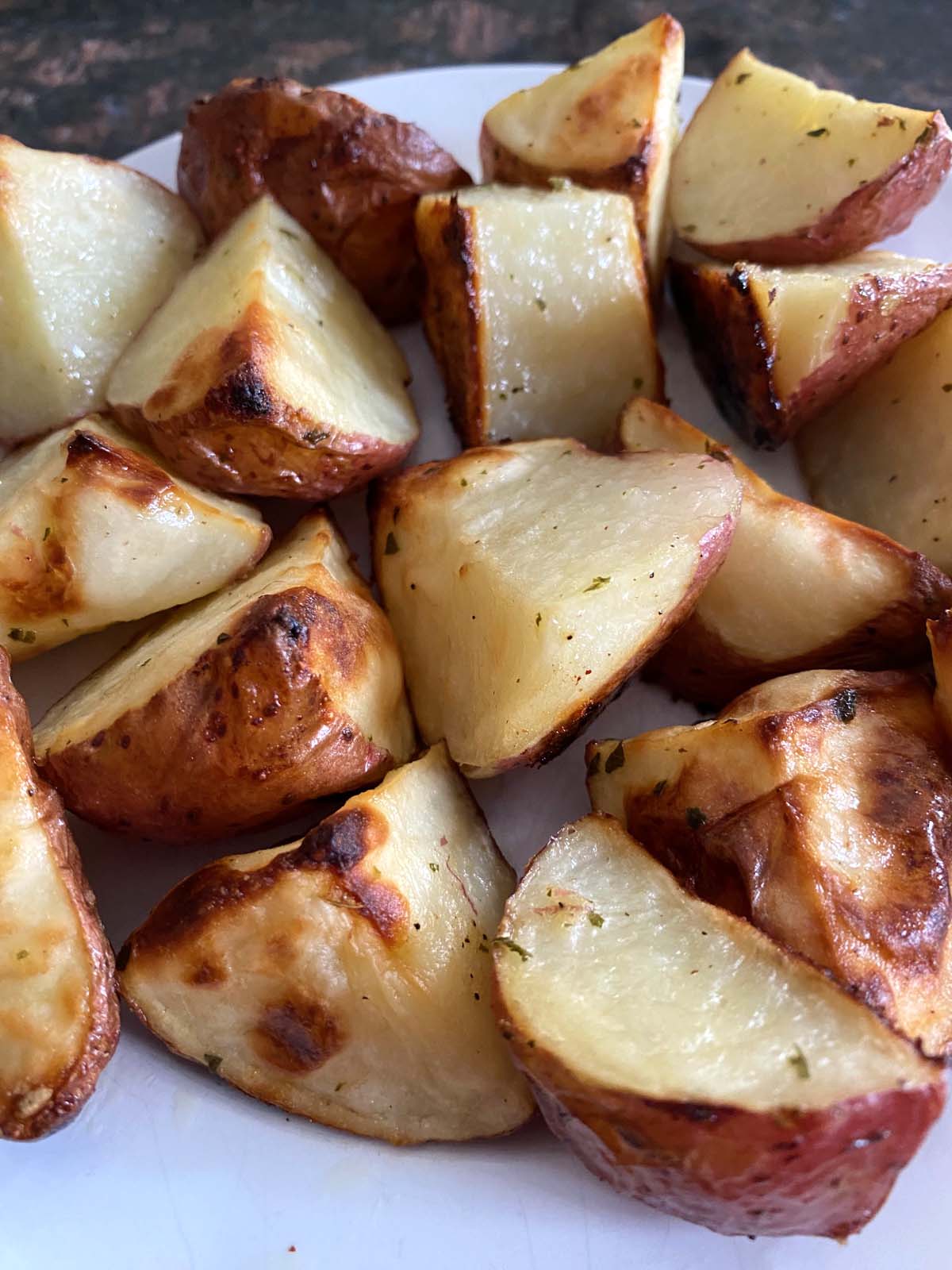 Ranch roasted potatoes on a white plate.