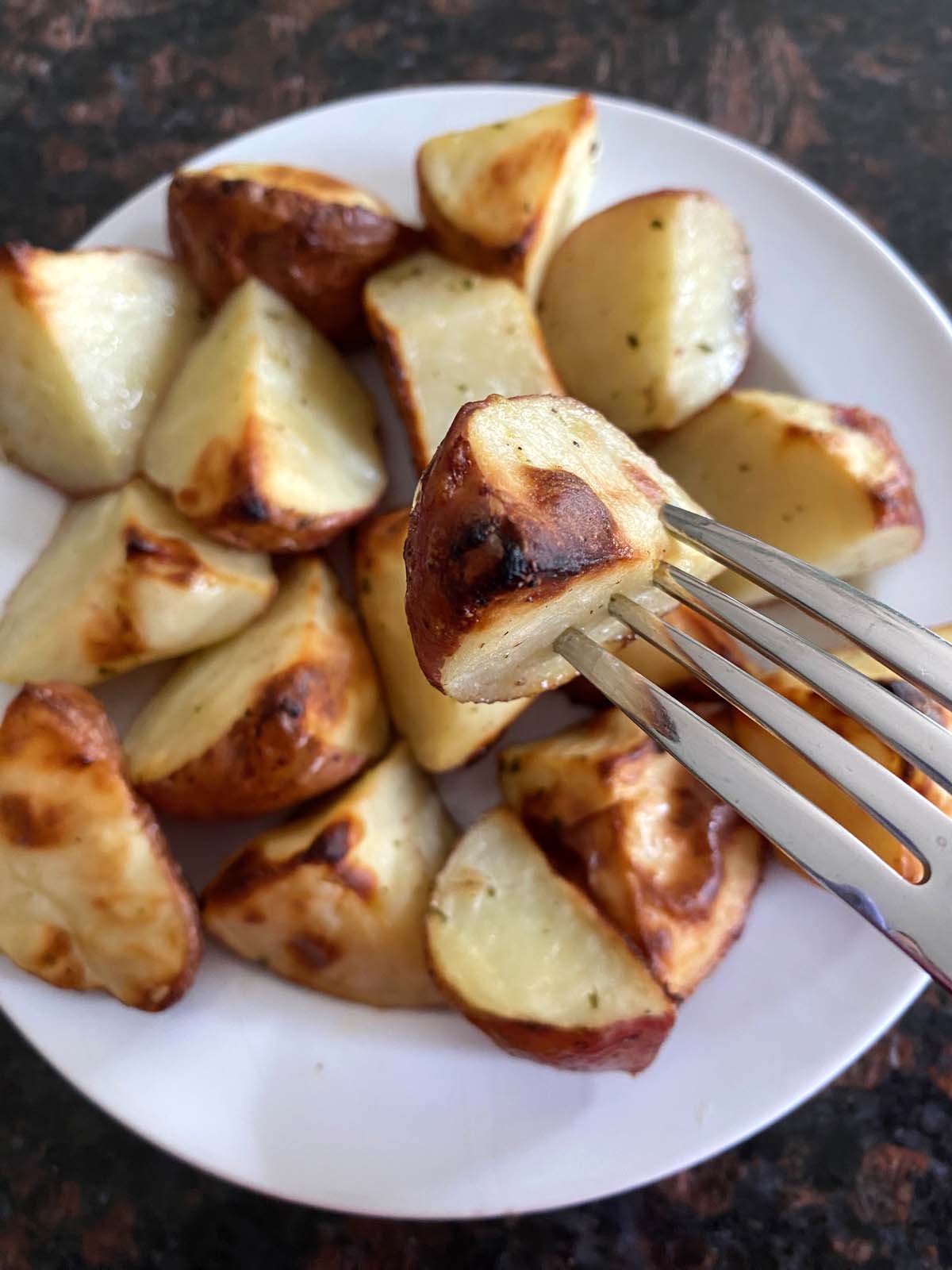Ranch roasted potatoes on a white plate.