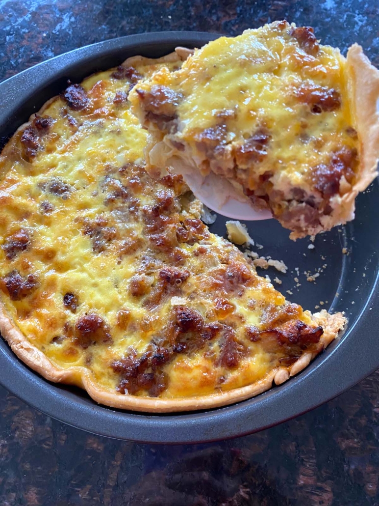 spatula holding slice of Sausage Quiche