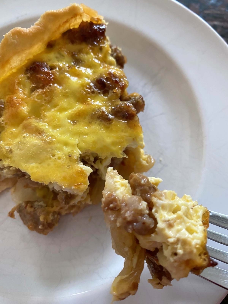 fork holding piece of Sausage Quiche