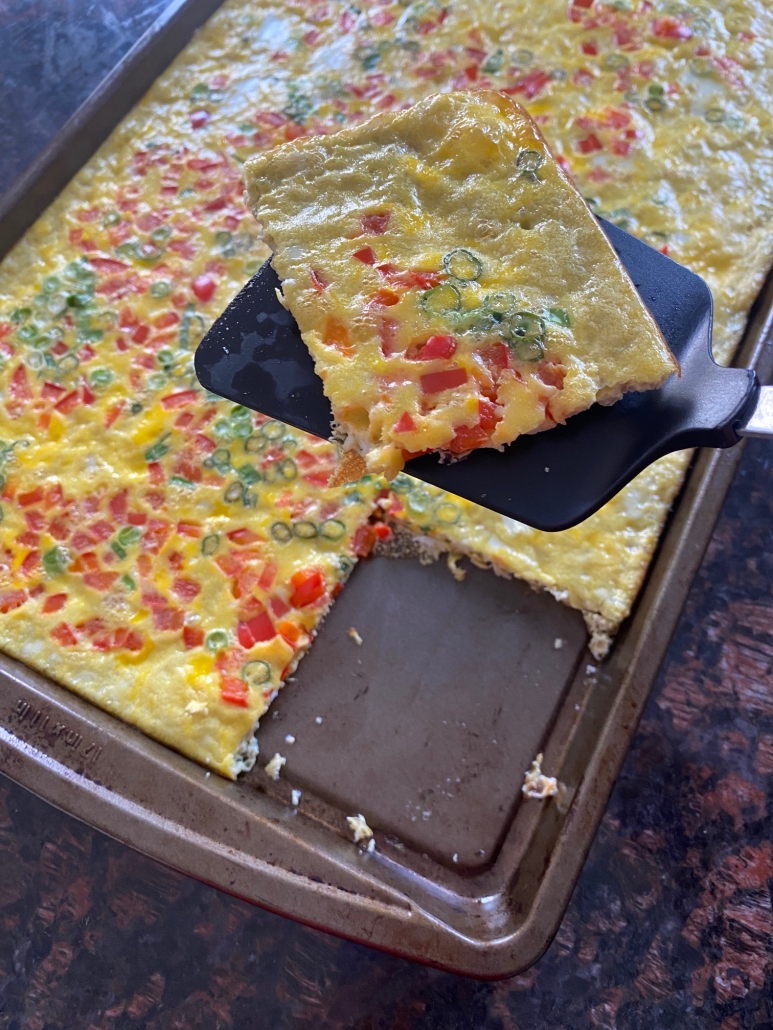 spatula holding slice of Sheet Pan Eggs