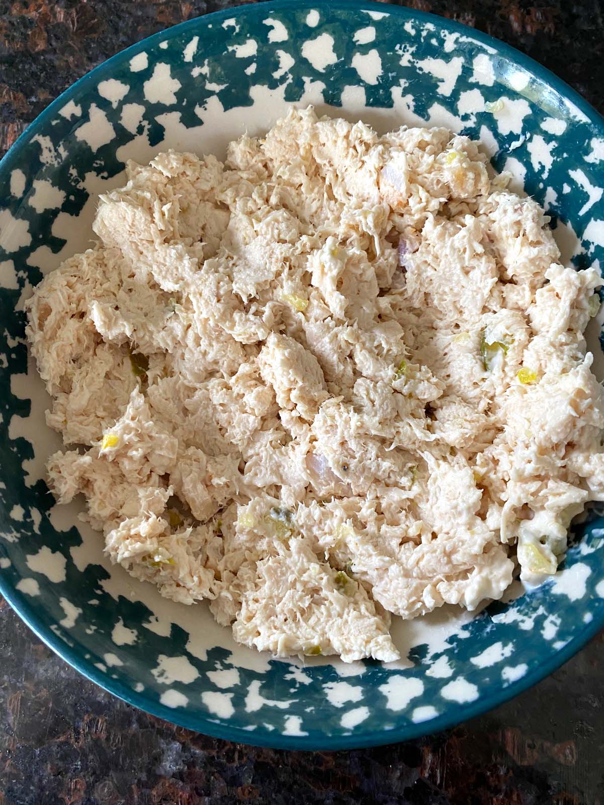 Shredded chicken salad in a bowl.