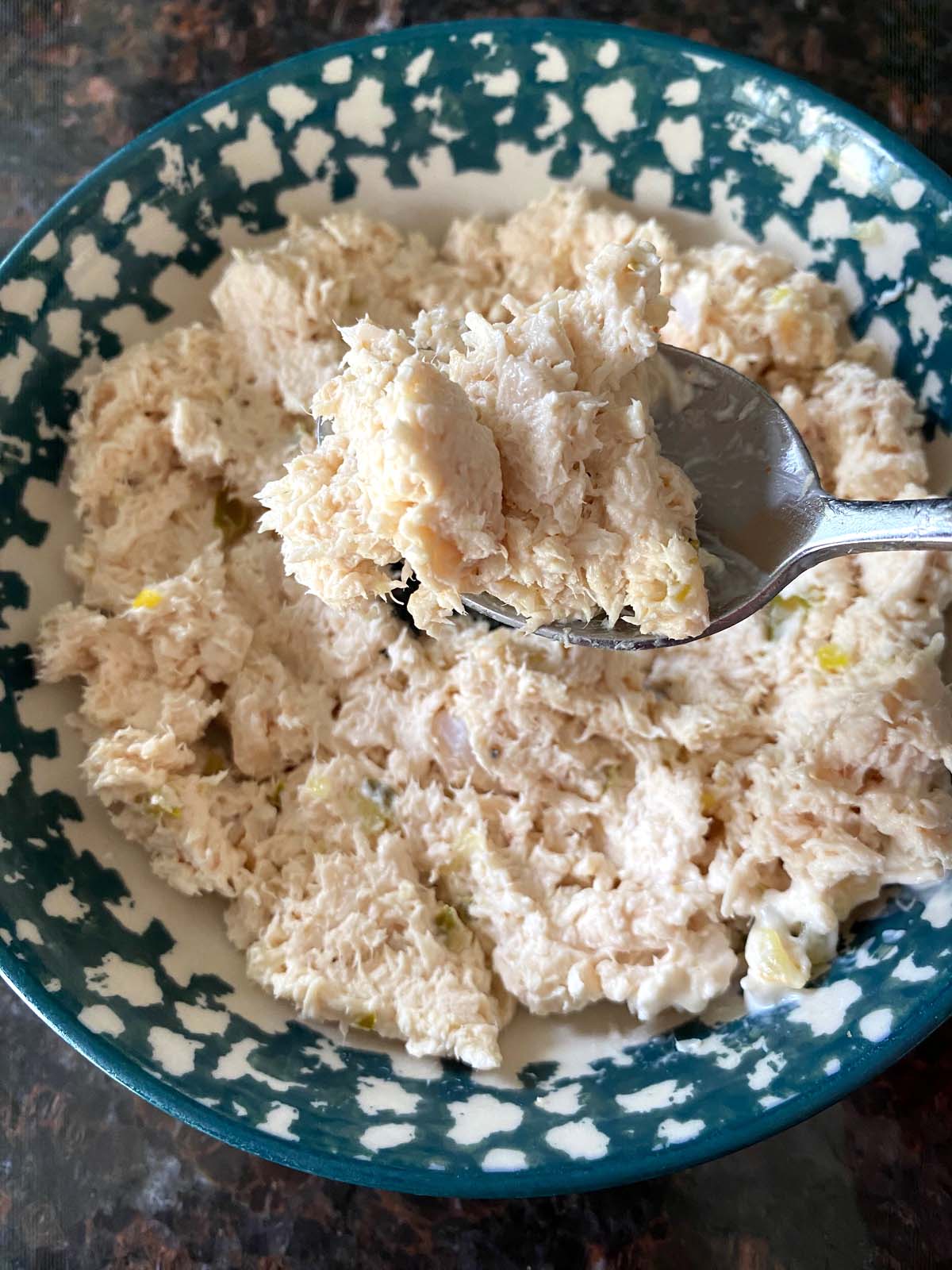 Shredded chicken salad in a bowl.