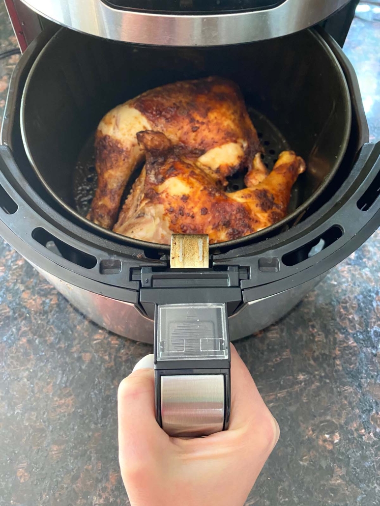 air fryer opened to show Air Fryer Chicken Leg Quarters
