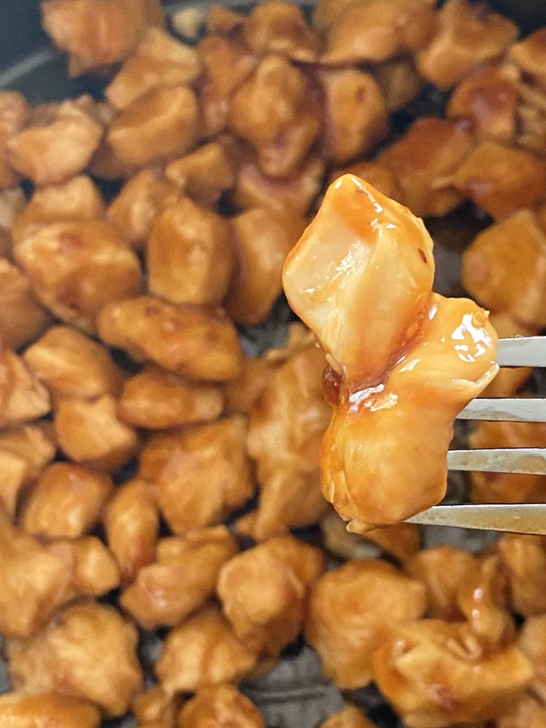 fork holding piece of Air Fryer Chicken Teriyaki coated in sauce