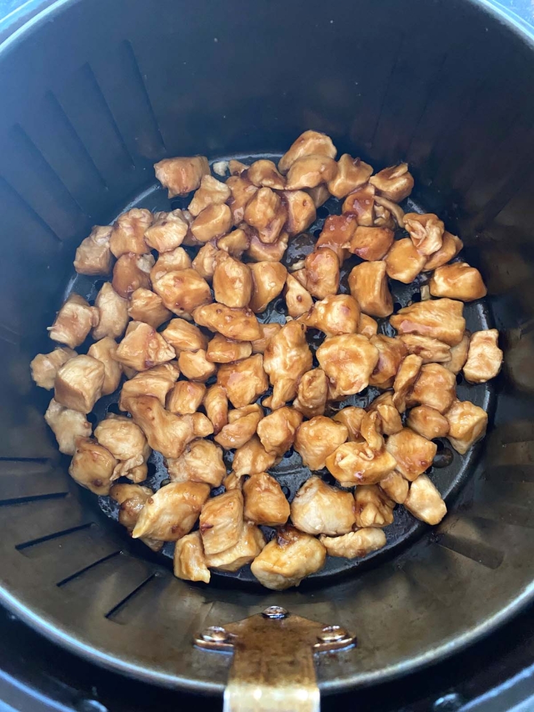 Chicken Teriyaki pieces in air fryer basket