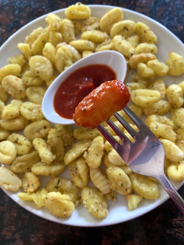 Air Fryer Gnocchi dipped in marinara sauce