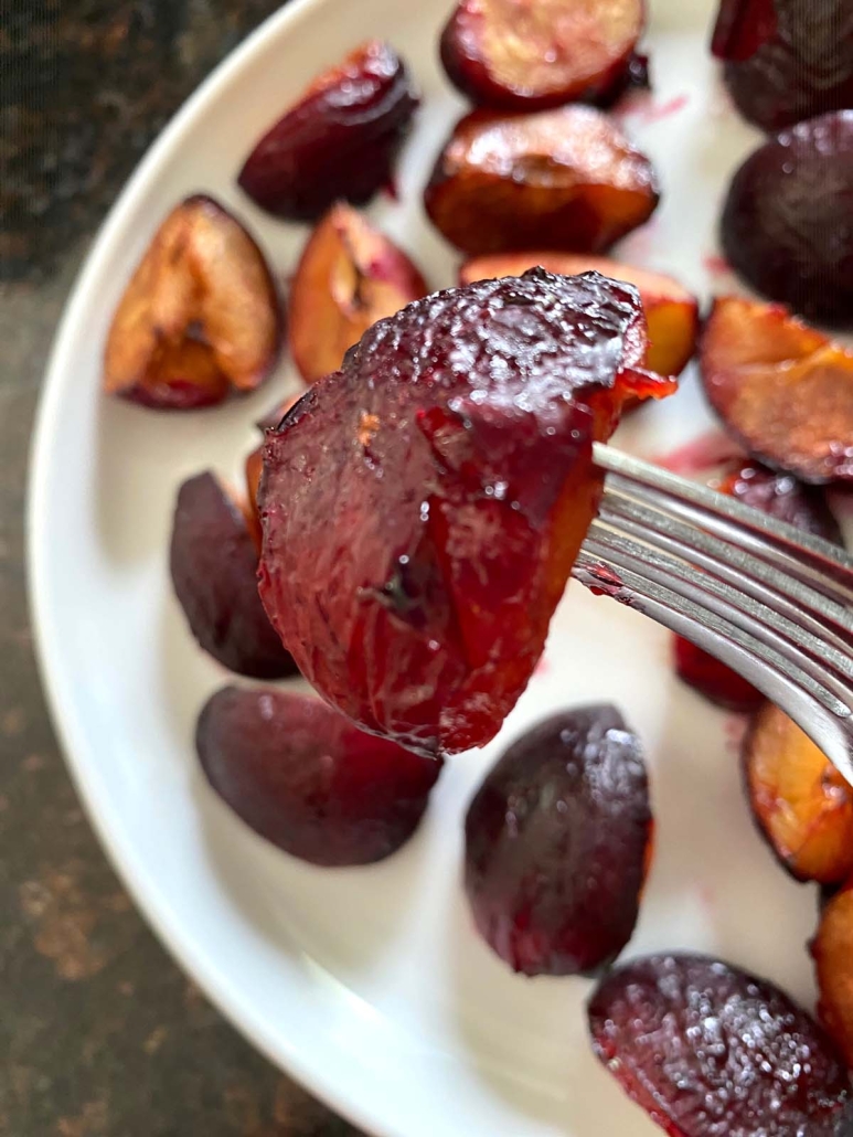 fork holding piece of air fryer roasted plum