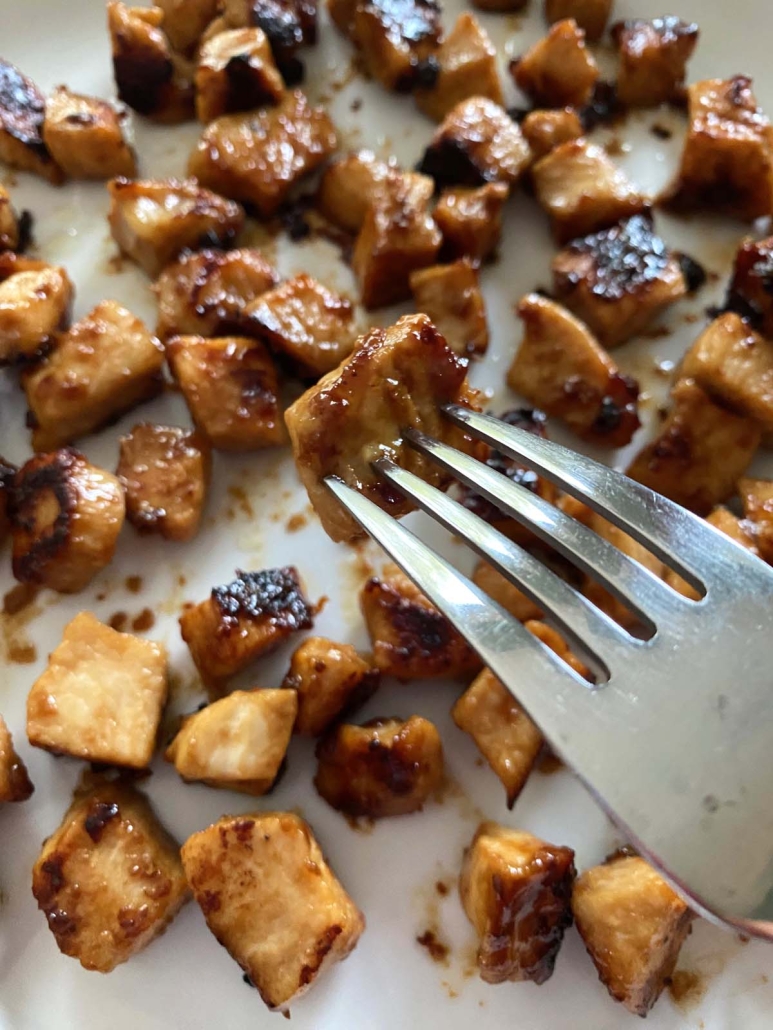 fork holding piece of cooked Hibachi Chicken