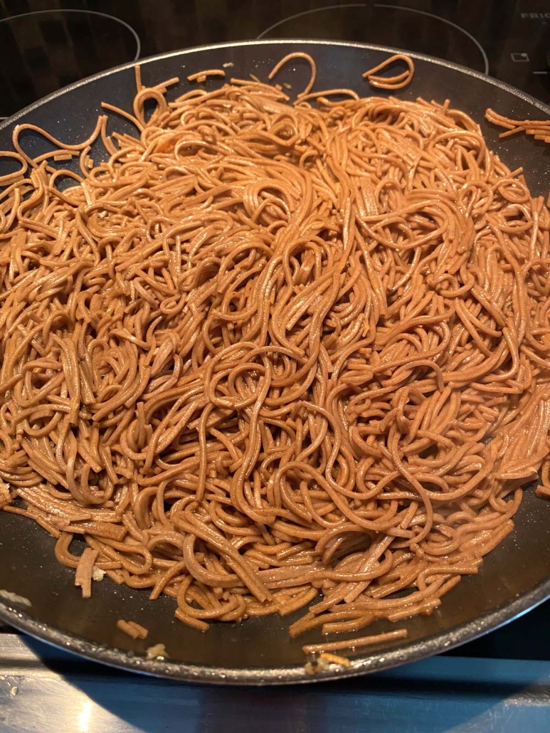 Hibachi Noodles cooking in a skillet