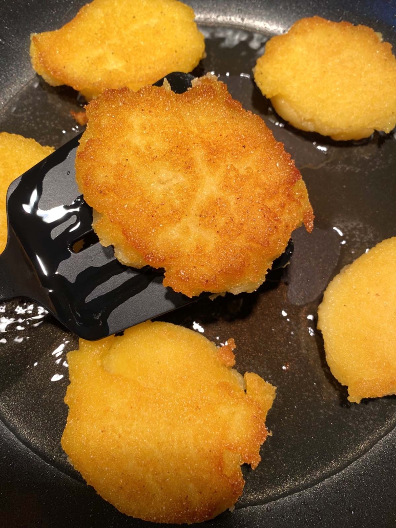 close-up of Hot Water Cornbread cooking on the stovetop