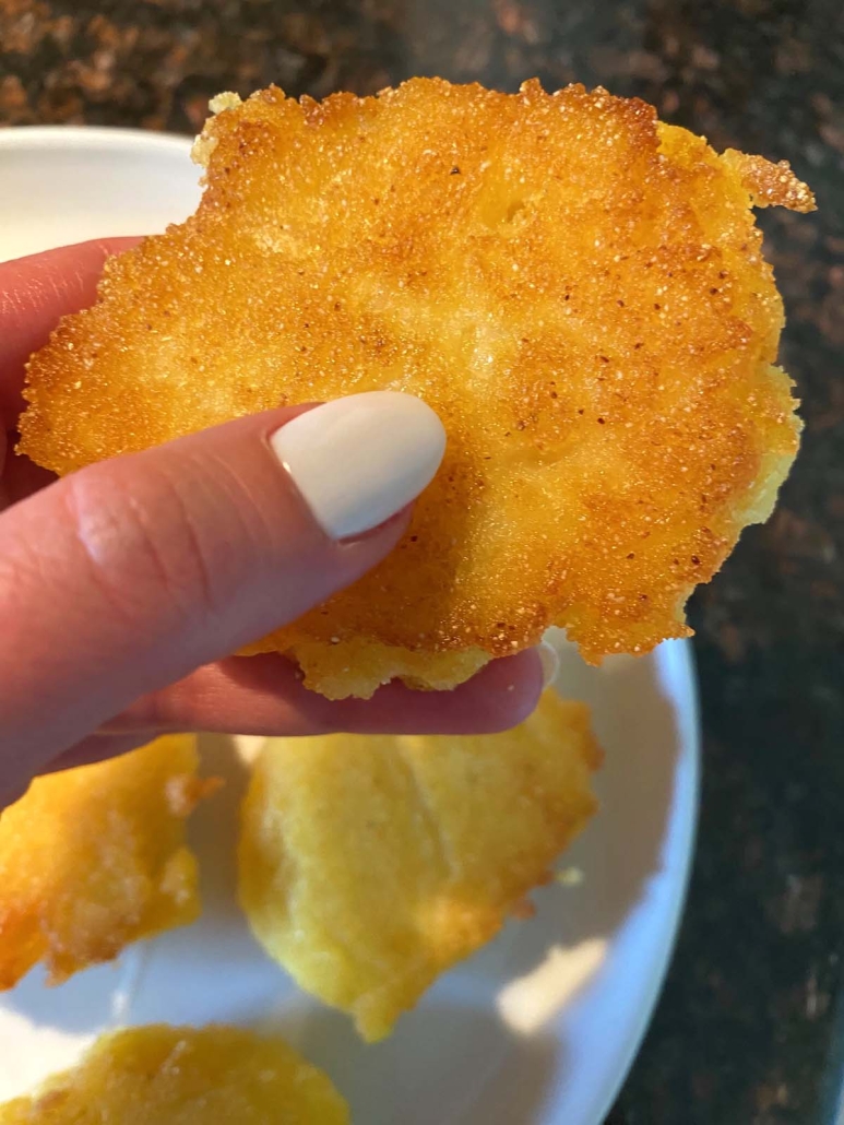 hand holding golden brown Hot Water Cornbread