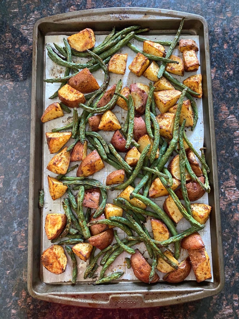 Roasted Potatoes And Green Beans on a baking sheet