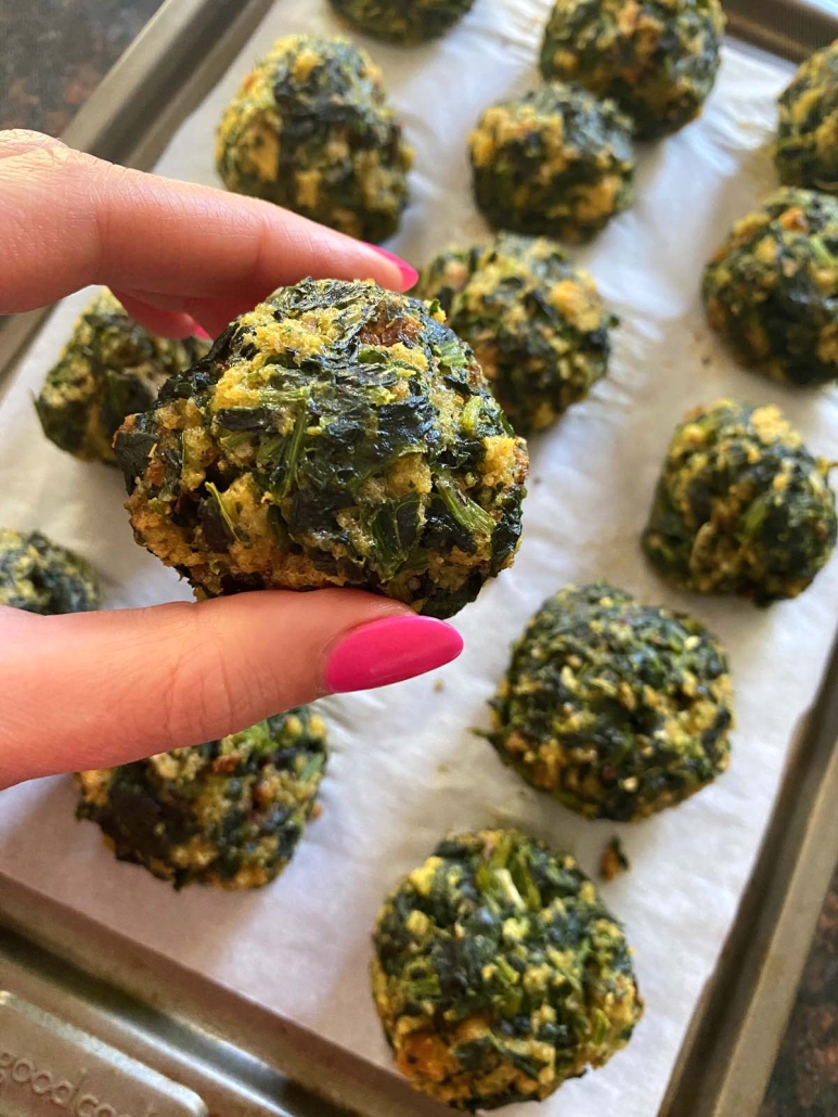 hand holding baked Spinach Ball With Stuffing