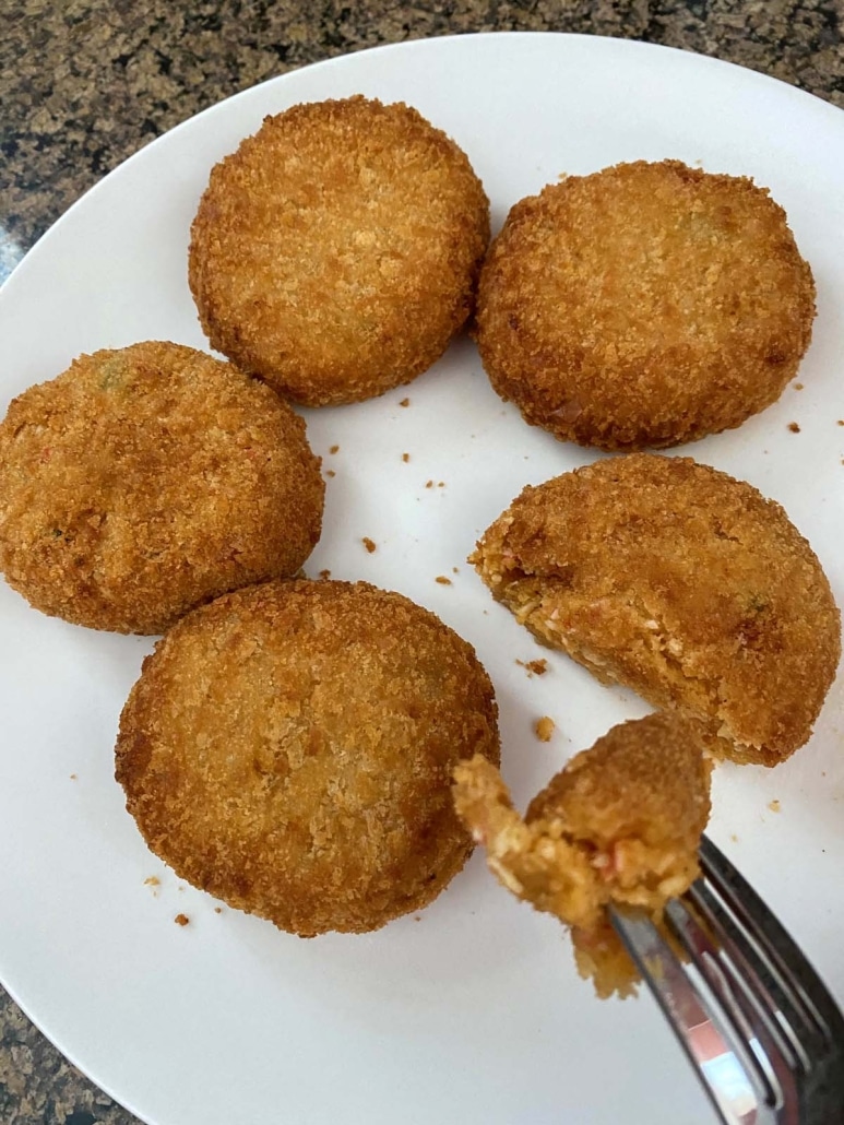 fork holding piece of Lobster Cakes