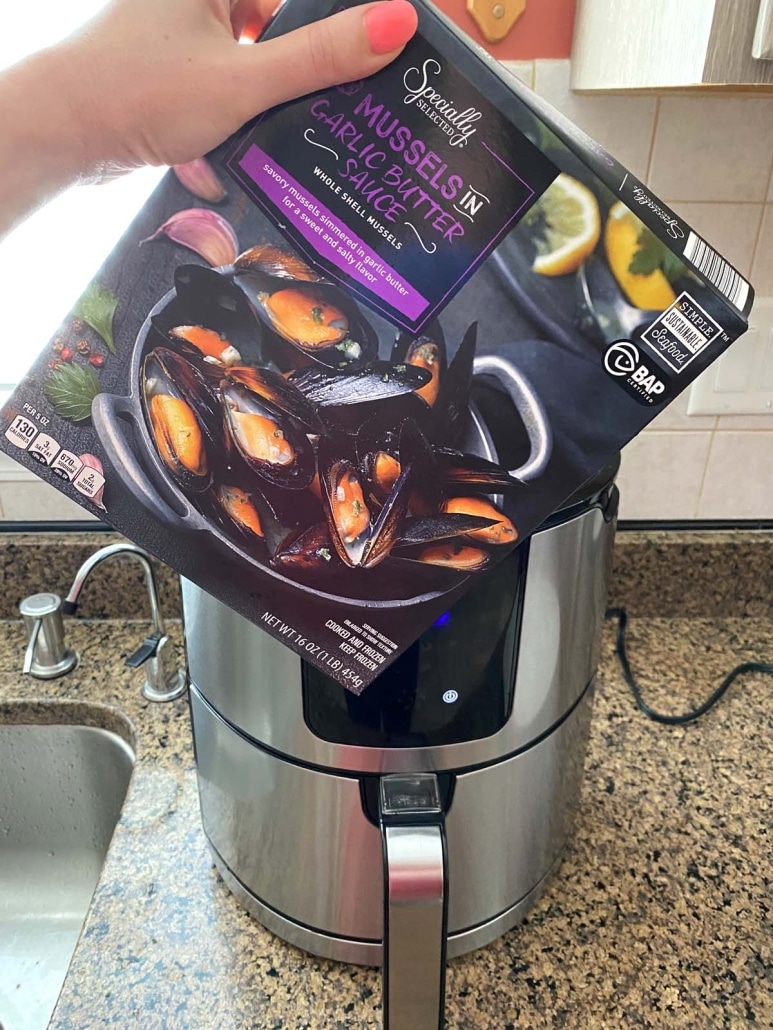 package of frozen mussels in front of air fryer