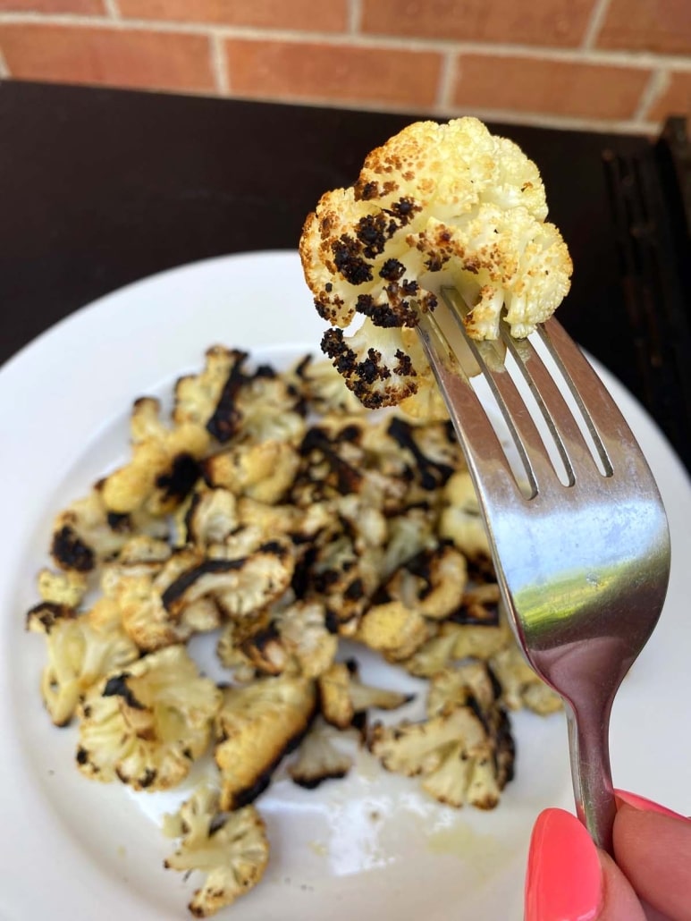 fork holding piece of cauliflower floret