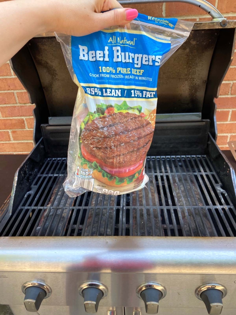 package of frozen burgers in front of grill